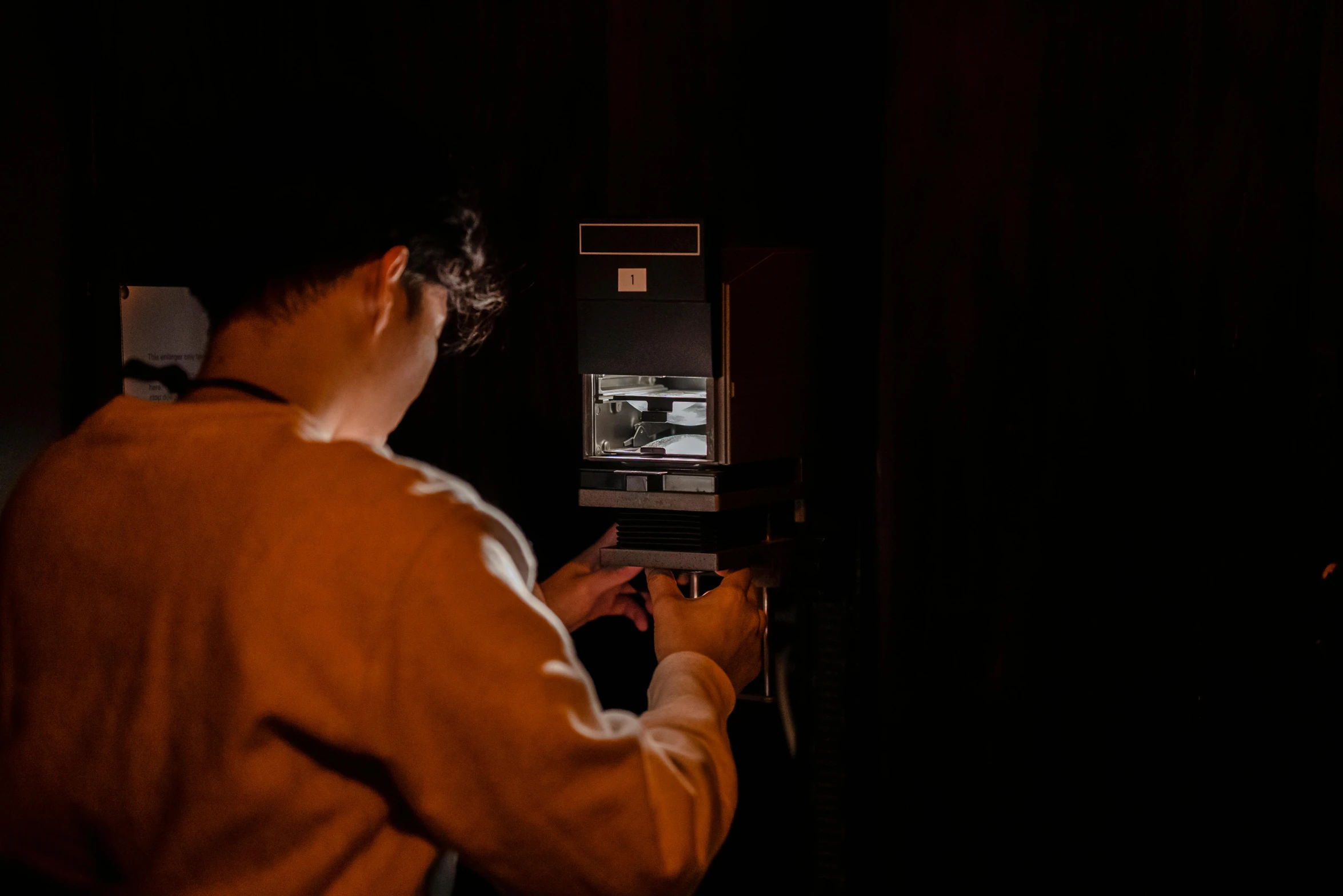 a man using an atm machine in the dark, inspired by Elsa Bleda, pexels contest winner, holography, photo taken on an old box camera, holding a camera, an escape room in a small, ignant