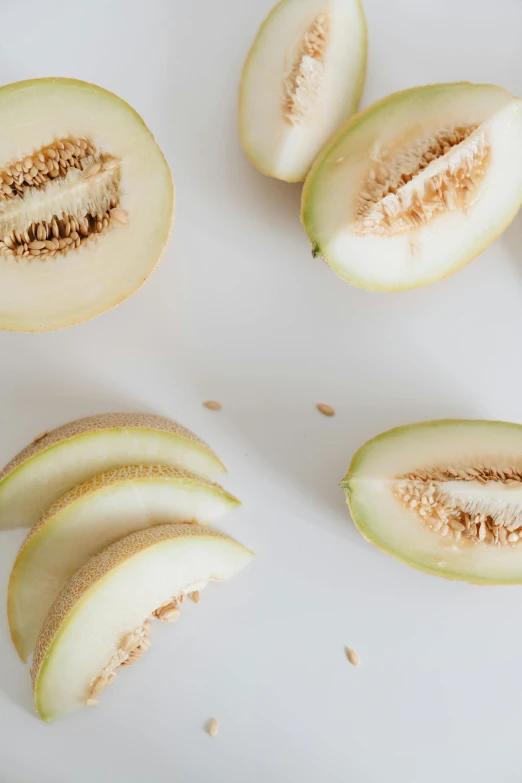 a white plate topped with slices of melon, a picture, by Matthias Stom, trending on unsplash, renaissance, beige, pear, full frame image, multiple stories