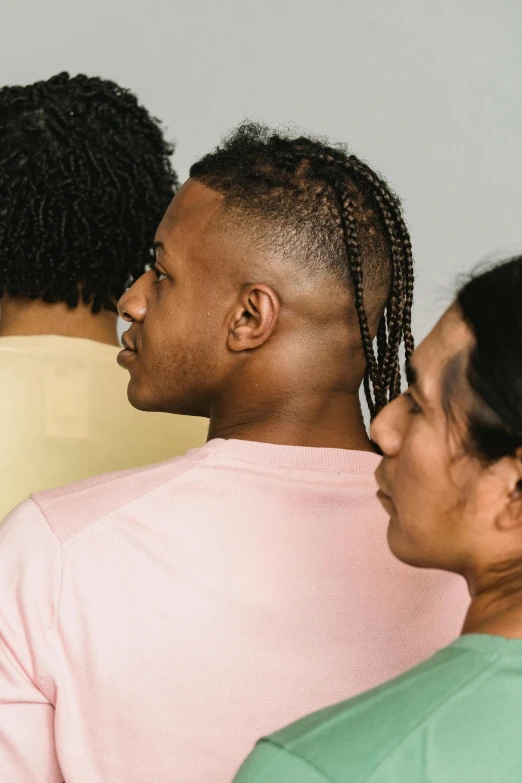 a group of people standing next to each other, by Carey Morris, trending on pexels, renaissance, diverse haircuts, hair gel combed backwards, queer, complex braided hair