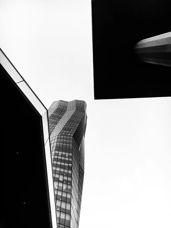 a black and white photo of some tall buildings, inspired by Zaha Hadid, unsplash contest winner, surrealism, full of glass. cgsociety, square, alvar aalto, twisted shapes