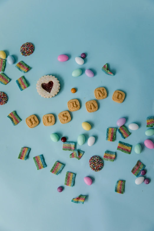 a blue plate topped with cookies and candies, an album cover, by Julia Pishtar, trending on pexels, hurufiyya, gay pride, asset on grey background, photograph 3 5 mm, 256435456k film