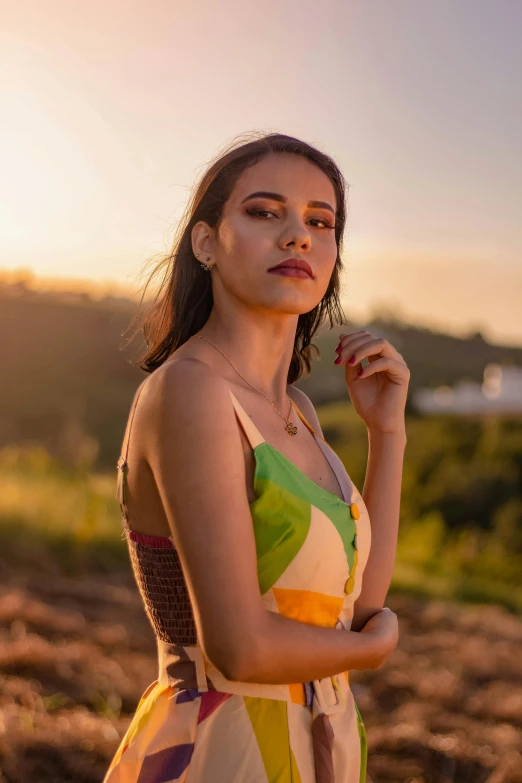 a woman in a colorful dress standing in a field, trending on pexels, brazilan supermodel, wearing a vest top, avatar image, portait photo