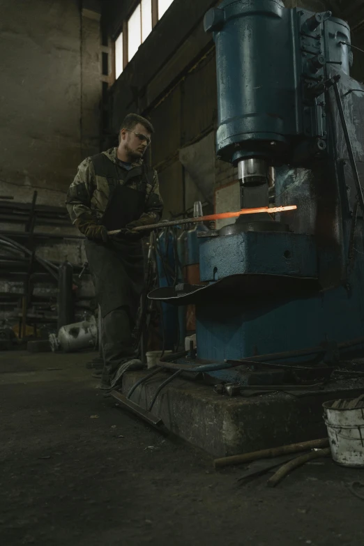 a man working on a machine in a factory, a portrait, pexels contest winner, renaissance, heavy weapons guy, profile image, forged, high compression