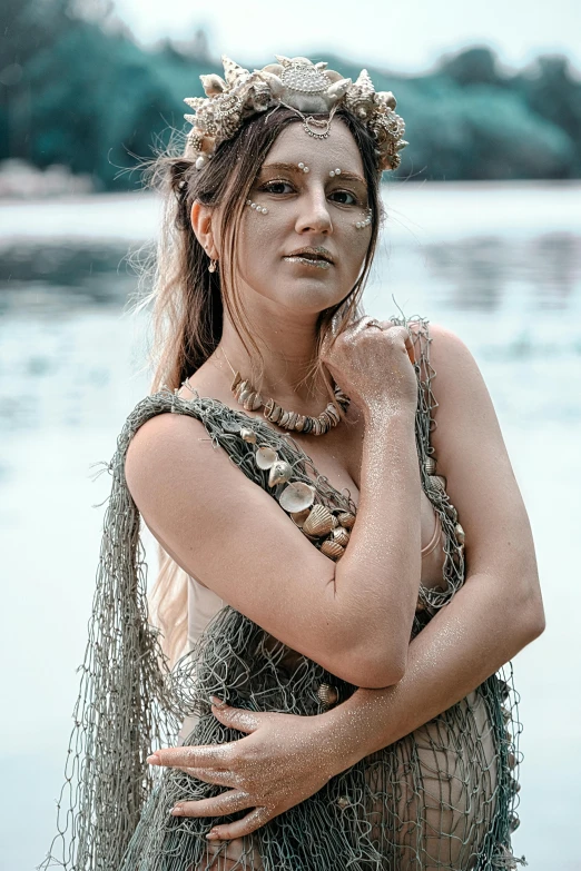 a woman standing next to a body of water, an album cover, pexels contest winner, renaissance, jeweled costume, boho neutral colors, mermaids, portrait image