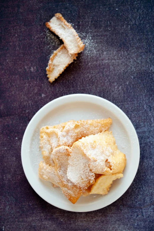 a close up of a plate of food on a table, powdered sugar, thumbnail, battered, wide angel shot