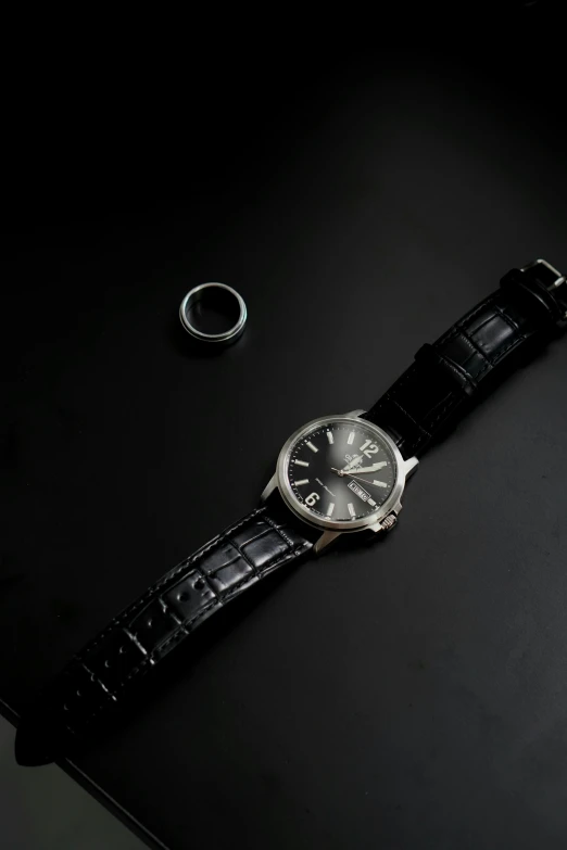 a watch sitting on top of a black table, a still life, asset on grey background, f/1.3, conor walton, day time