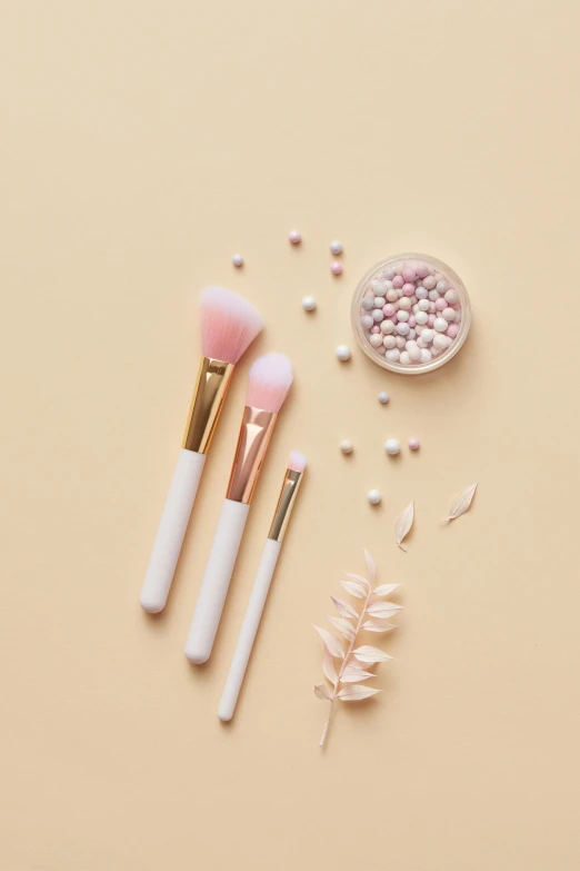 makeup brushes and pearls on a beige background, inspired by Pearl Frush, plasticien, white and light-pink outfit, detailed product image, bloomy, gold