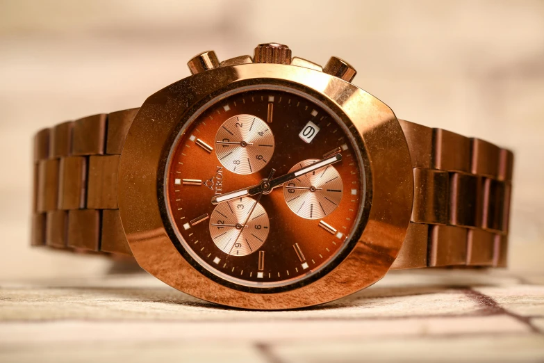 a close up of a watch on a table, pexels contest winner, hyperrealism, reflections in copper, reddish - brown, fuji provia, gold