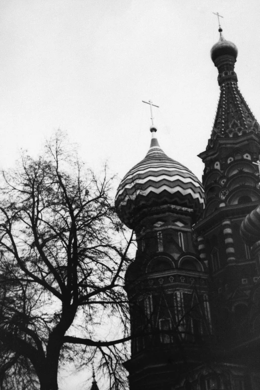 a black and white photo of a tall building, inspired by Vasily Surikov, symbolism, church in the wood, ( ( photograph ) ), red square, shot with a arriflex 35 ii