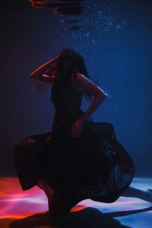 a woman in a black dress under water, sza, dramatic colored lighting, photographed for reuters, dance scene