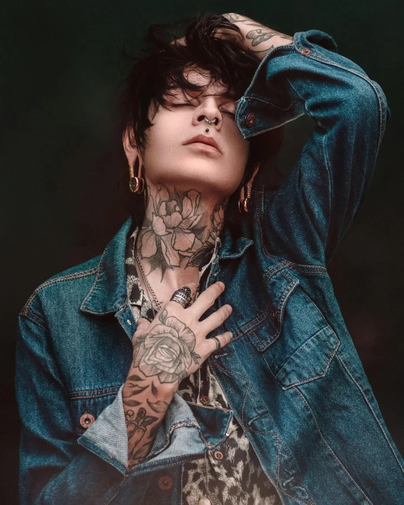 a man with a tattoo on his arm, inspired by Elsa Bleda, trending on pexels, beautiful androgynous girl, jungkook, jean jacket, detailed face and body