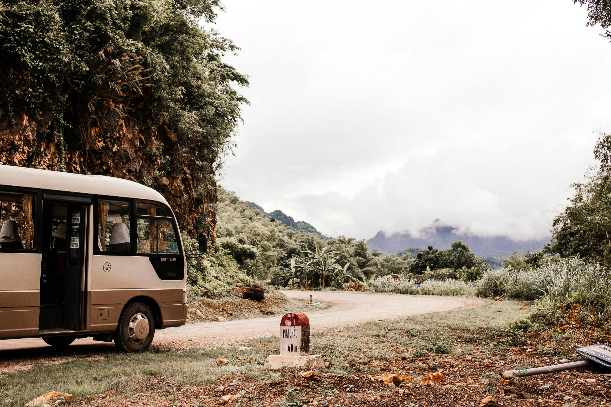 a bus parked on the side of a dirt road, unsplash, visual art, reunion island, profile image, vietnam, injured