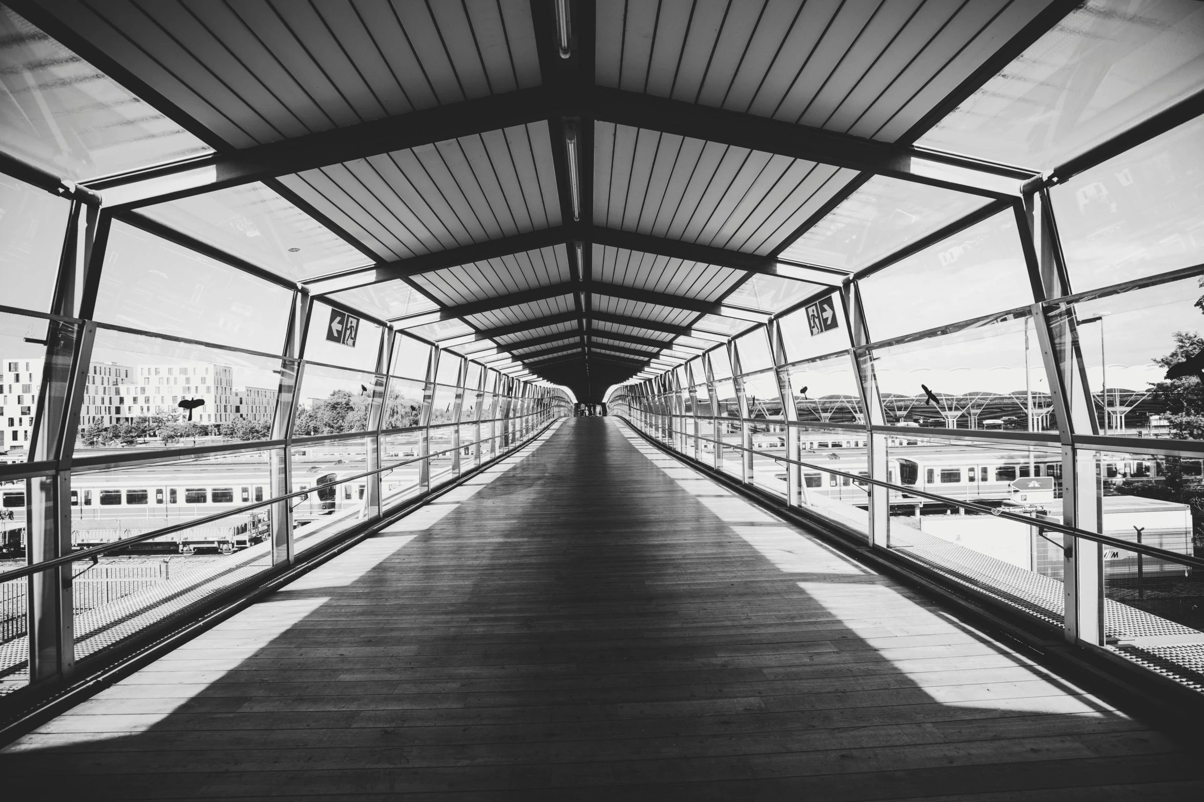 a black and white photo of a walkway, pexels contest winner, monorail, symmetrical outpost, on the deck of a ship, trending on vsco