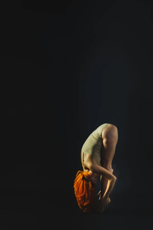 a person doing a trick on a skateboard, a portrait, by Elizabeth Polunin, arabesque, bent over posture, woman with red hair, on black background, marjaryasana and bitilasana