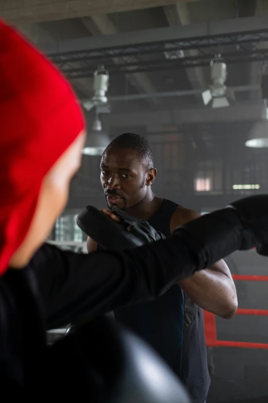 a man standing next to a woman in a boxing ring, inspired by Rajmund Kanelba, happening, medium close - up ( mcu ), square, production photo, bank robbery movies