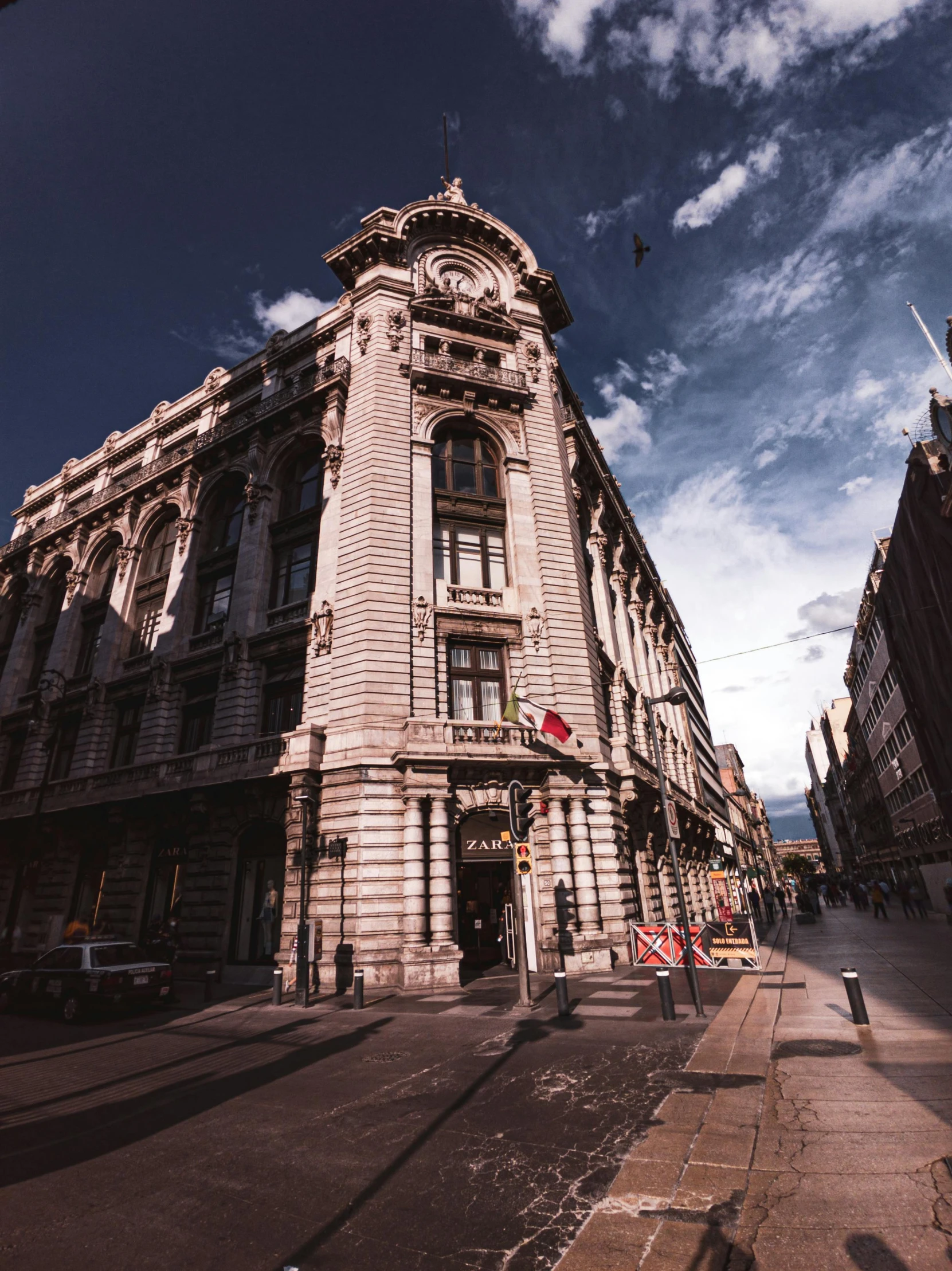 a very tall building sitting on the side of a street, a photo, pexels contest winner, art nouveau, hungarian, magnificent super wide angle, neoclassical police station, youtube thumbnail