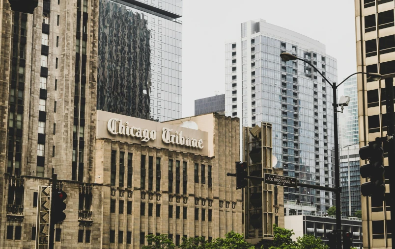 a city street filled with lots of tall buildings, a photo, by Robbie Trevino, unsplash contest winner, graffiti, chicago, newspaper photo, “ golden chalice, 1910s architecture