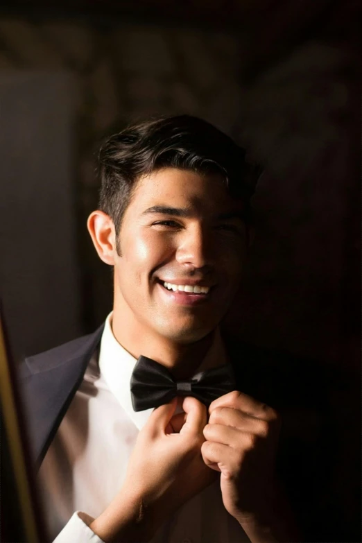 a man adjusting his bow tie in front of a mirror, inspired by Ramon Pichot, smiling :: attractive, half asian, promotional image, david marquez