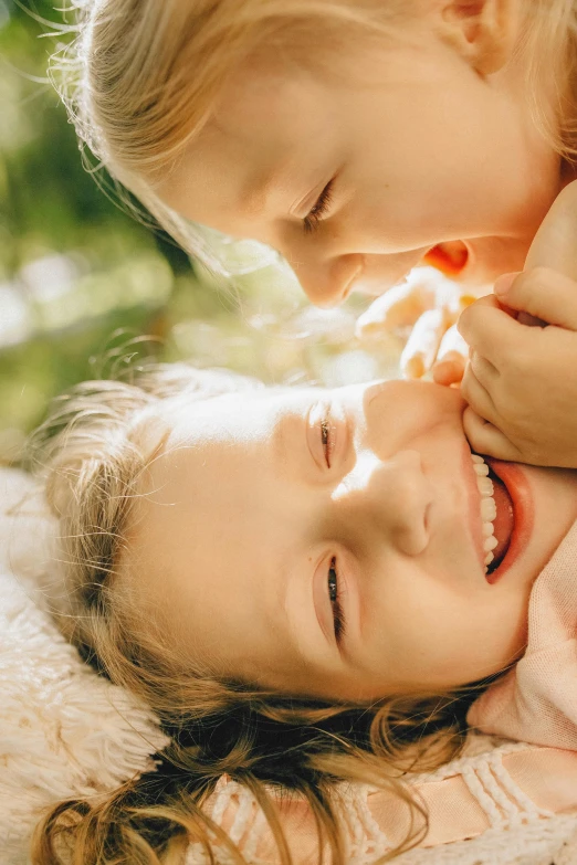 a couple of little girls laying on top of each other, a picture, shutterstock, incoherents, soft light 4 k, bite her lip, 15081959 21121991 01012000 4k, sun is shining