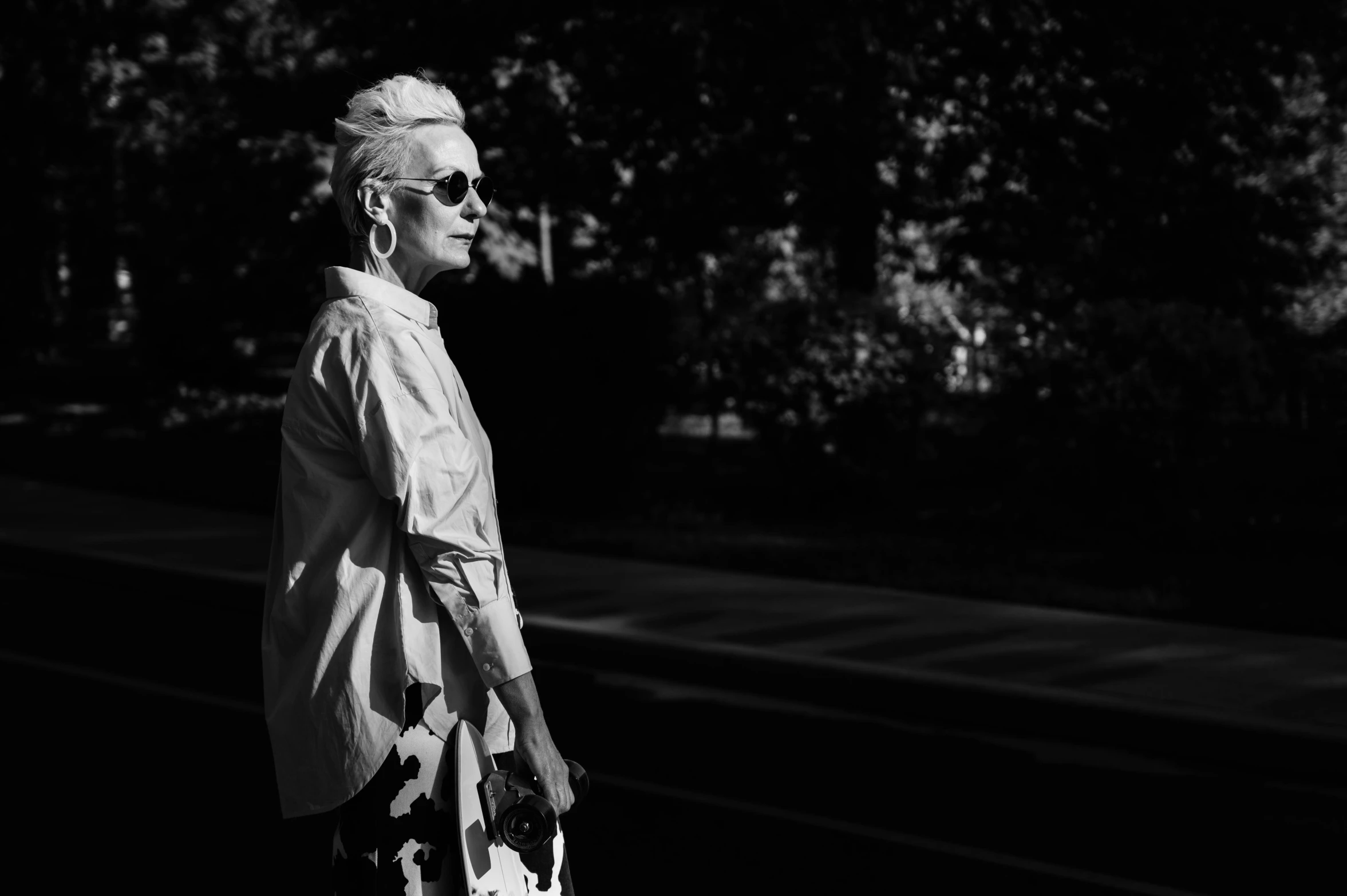 a black and white photo of a woman walking down the street, unsplash, silver hair (ponytail), dark shades, andrzej marszalek, 15081959 21121991 01012000 4k