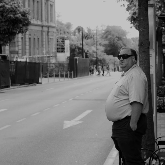 a man standing on the side of a street next to a bike, inspired by Thomas Struth, pexels contest winner, realism, obese ), singapore ( 2 0 1 8 ), happy wise. he has bouncy belly, an oldman