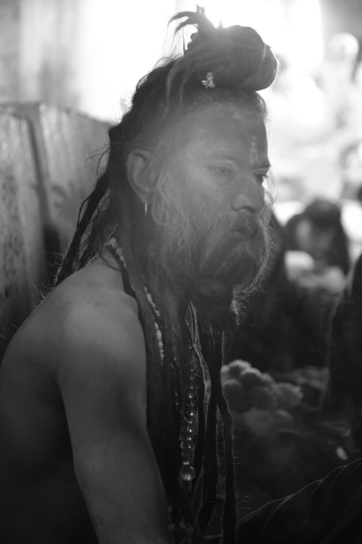 a black and white photo of a man with long hair, by Thomas Fogarty, reddit, sumatraism, ritual occult gathering, ox, photograph taken in 2 0 2 0, bearded