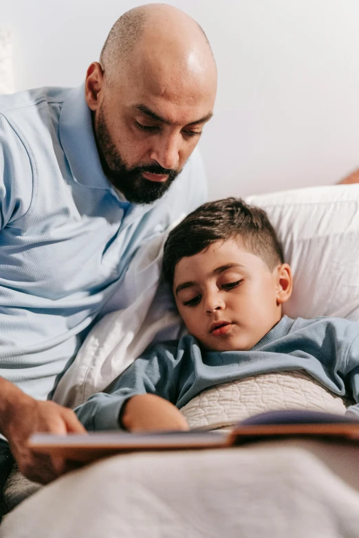 a man reading a book to a young boy, laying in bed, connectivity, subtle detailing, operation