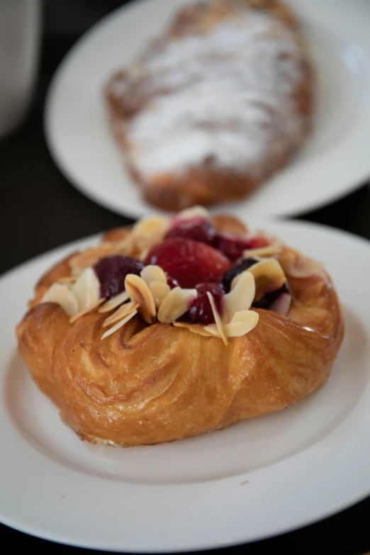 a pastry sitting on top of a white plate, melbourne, profile image, petite, breakfast