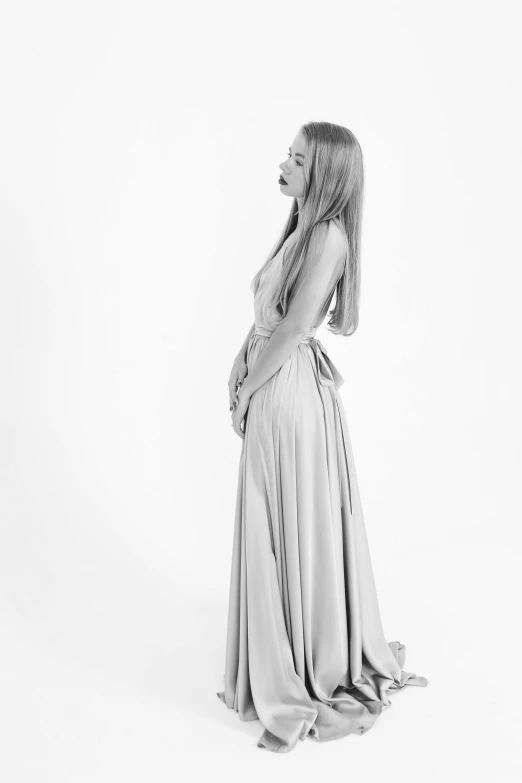 a black and white photo of a woman in a long dress, sleek blond hair, back, ese