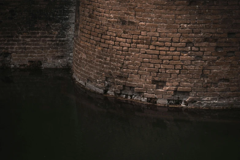 a red fire hydrant sitting next to a brick wall, inspired by Hubert Robert, unsplash contest winner, australian tonalism, glare on the water, ancien chinese tower, alessio albi, curved bridge