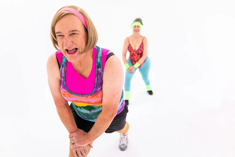 a couple of women standing on top of a snow covered ground, dribble, sheryl sandberg at soulcycle, fancy dress, 8 0 s sport clothing, vibrant colour