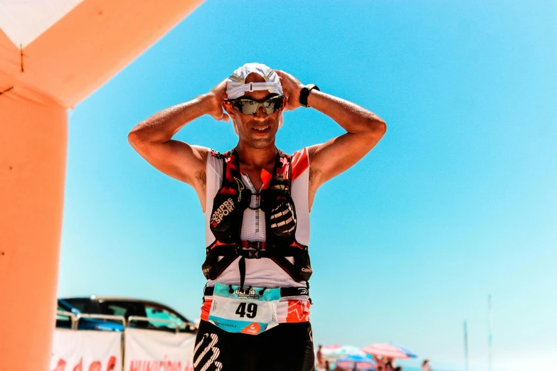 a man standing on top of a sandy beach, ironman, malika favre, avatar image, costa blanca