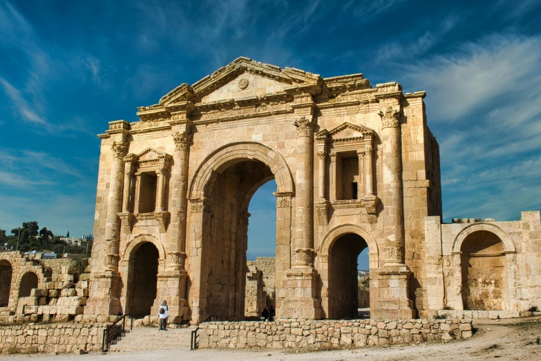 a man standing in front of a stone arch, by Julia Pishtar, pexels contest winner, neoclassicism, jordan, square, 3 doors, dezeen