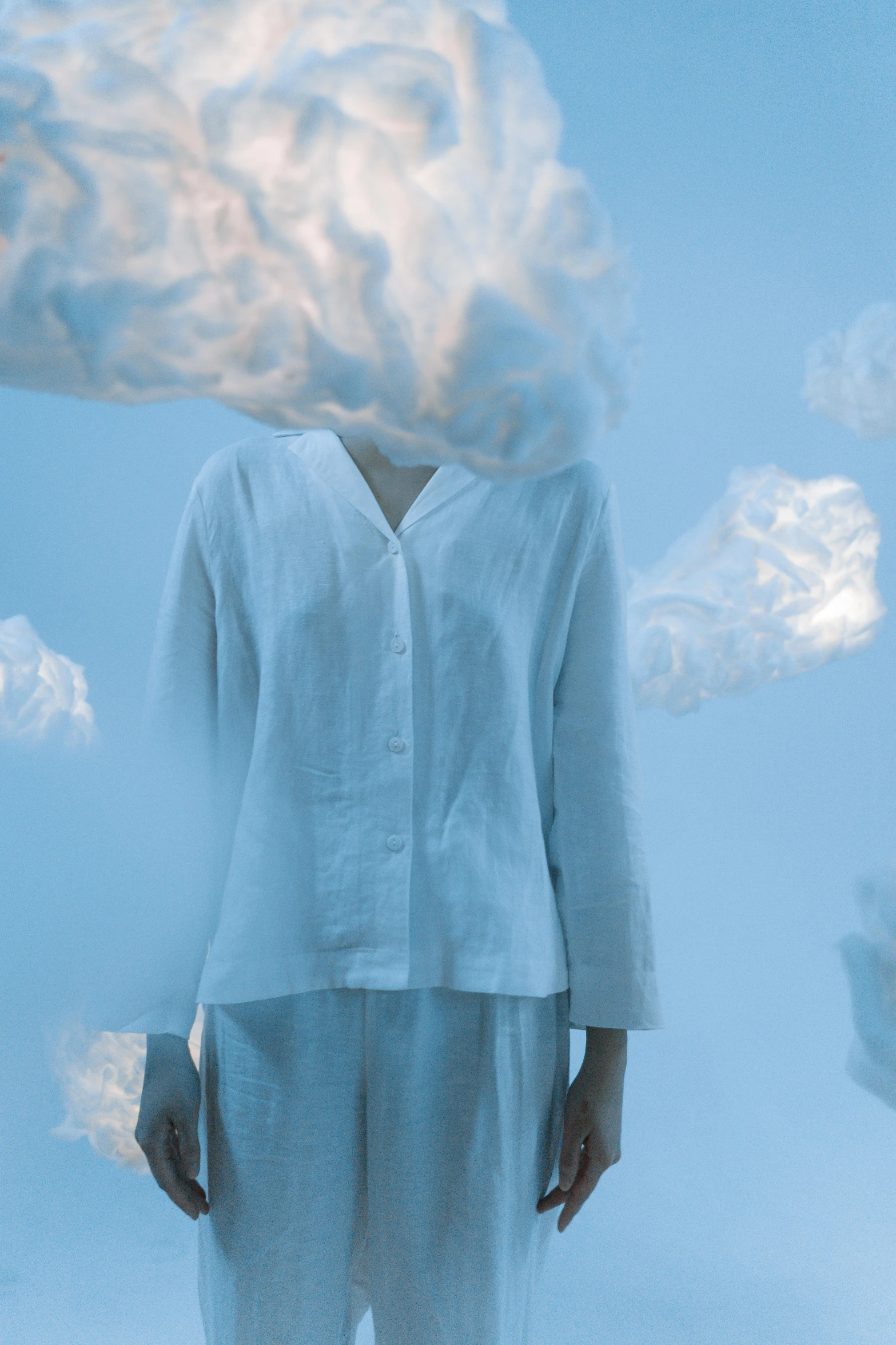 a woman with a cloud over her head, an album cover, inspired by René Magritte, pexels contest winner, wearing white pajamas, volumetric mist, wearing a linen shirt, rinko kawauchi