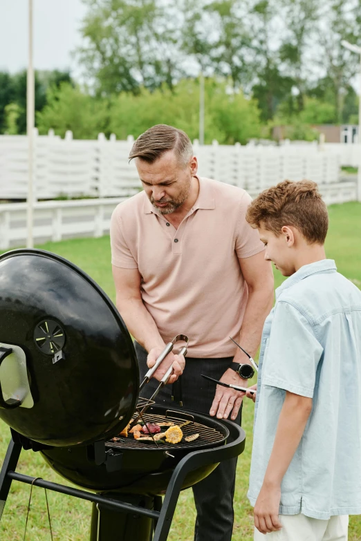 a man and a boy grilling food on a grill, netflix, make it spicey, product introduction photo, enamel