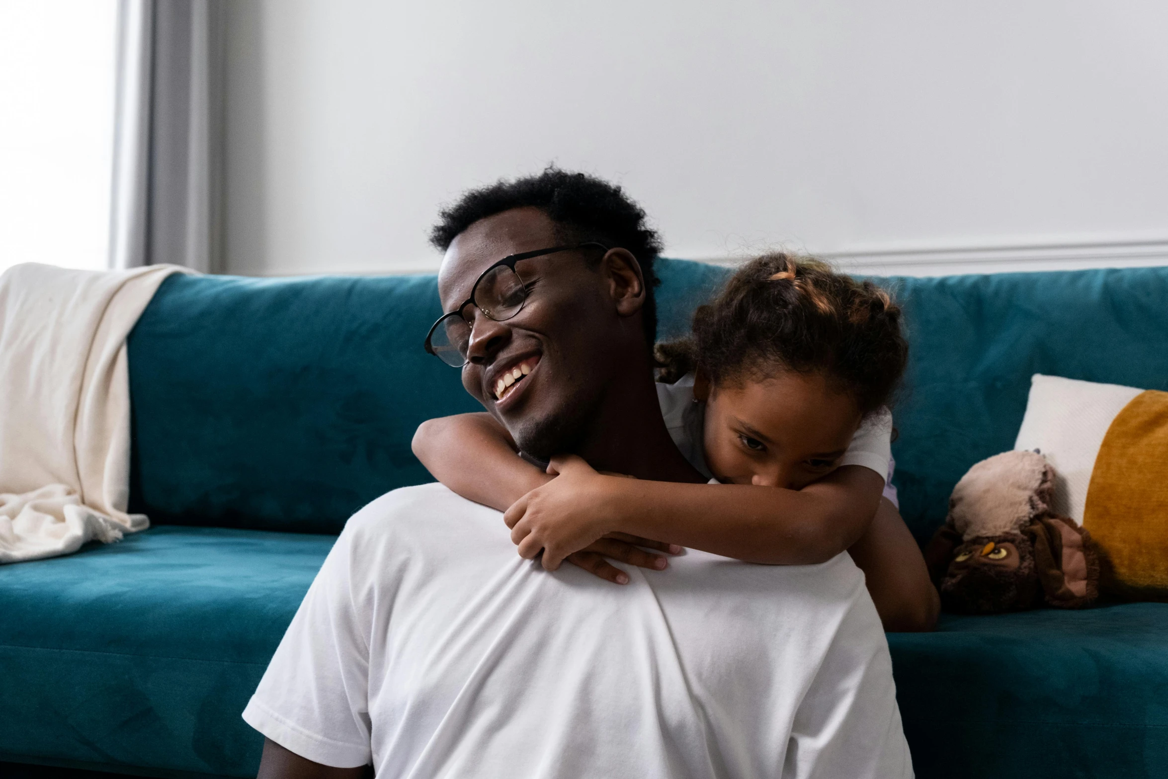 a man and a little girl hugging on a couch, pexels contest winner, hurufiyya, black people, dad bod, thumbnail, super high resolution