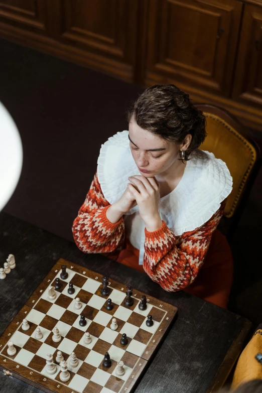 a woman sitting at a table playing a game of chess, a portrait, by Emma Andijewska, unsplash contest winner, renaissance, from the grand budapest hotel, 15081959 21121991 01012000 4k, sydney sweeney, youtube thumbnail