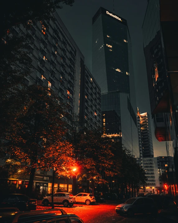 a city street filled with lots of tall buildings, pexels contest winner, dark lighting, fall season, it glows from the outside, architecture photo