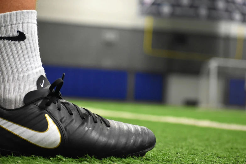 a close up of a soccer shoe on a field, indoor, shot on sony a 7, prosthetic limbs, 15081959 21121991 01012000 4k