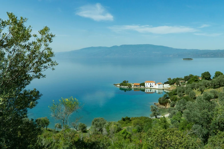 a large body of water surrounded by trees, by Julian Allen, pexels contest winner, mediterranean fisher village, alexandros pyromallis, panorama distant view, conde nast traveler photo