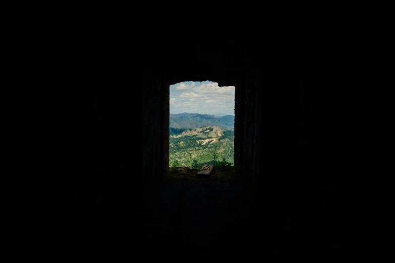 a window in a dark room with mountains in the background, an album cover, unsplash contest winner, renaissance, castle ruins, camera obscura, mediterranean vista, containing a hidden portal