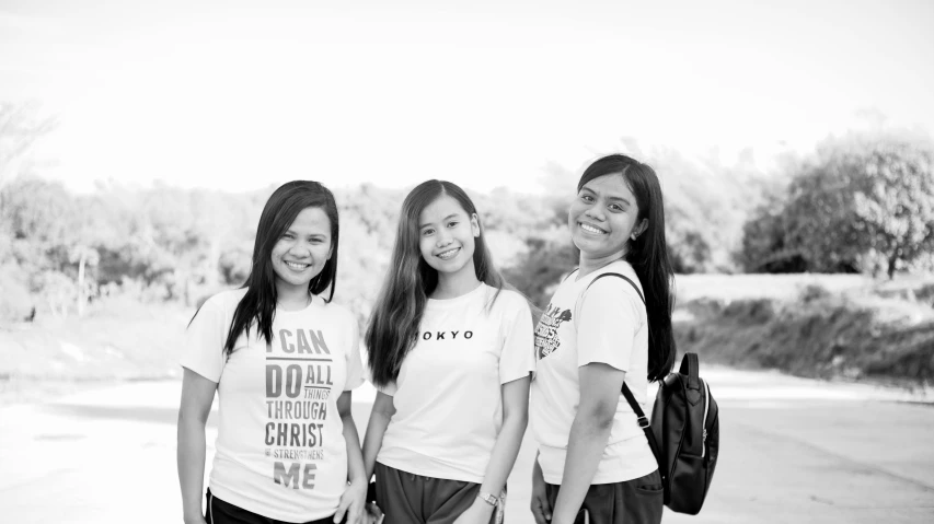 a group of young women standing next to each other, a black and white photo, by Robbie Trevino, dressed in a white t-shirt, ghailan!, three women, photographic print