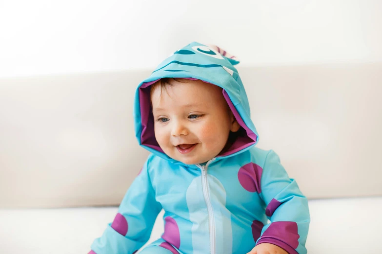 a baby sitting on a couch wearing a blue and purple costume, a cartoon, by disney, unsplash, swim suite, sea creature, square, detail shot