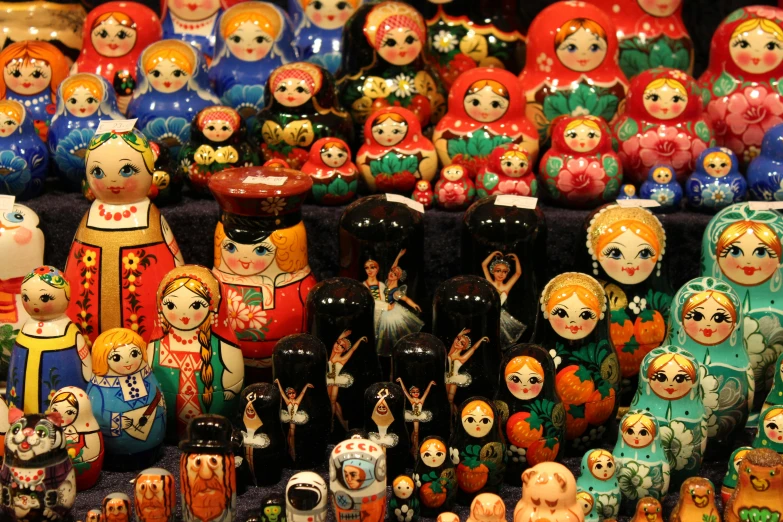 a bunch of dolls sitting on top of a table, pexels, qajar art, square, 000 — википедия, multi - coloured, a wooden