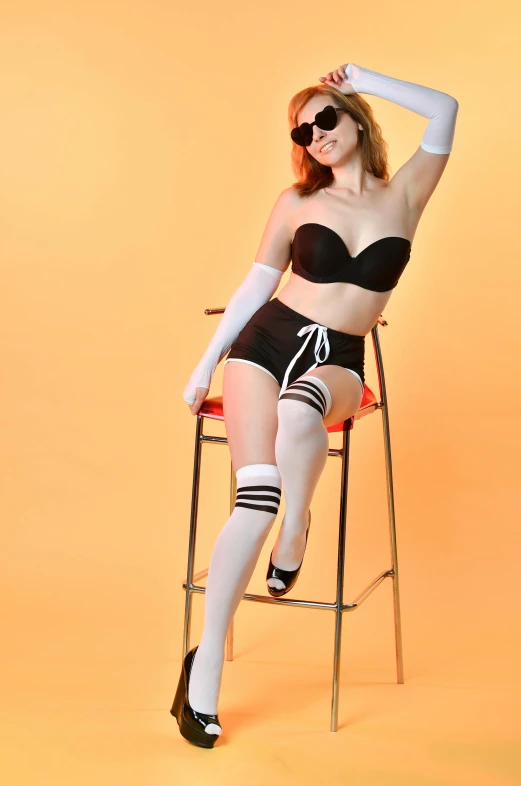 a woman that is sitting on a chair, inspired by Bunny Yeager, flickr, alex from a clockwork orange, wearing kneesocks, posing in bra, 15081959 21121991 01012000 4k