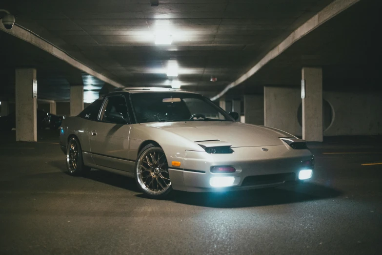 a car is parked in a parking garage, a portrait, inspired by Nōami, unsplash, japanese drift car, with glow on some of its parts, 90s photo, octane--8k