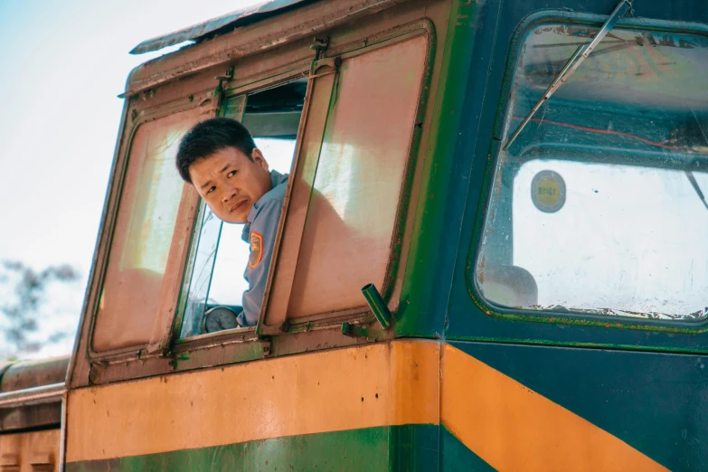 a man looking out the window of a train, jin shan and ross tran, driver, slightly round chin