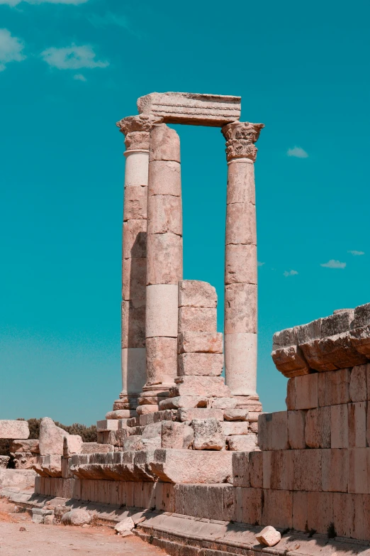 a couple of columns sitting on top of a dirt field, a marble sculpture, pexels contest winner, neoclassicism, clear blue skies, jordan, square, al - qadim