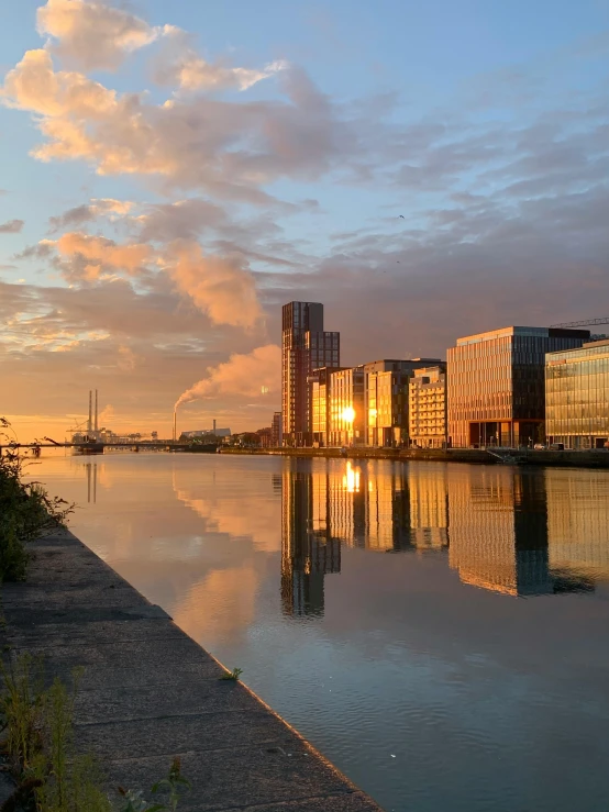 a large body of water next to a city, by Adriaen Hanneman, pexels contest winner, summer morning light, ireland, 2022 photograph, canal