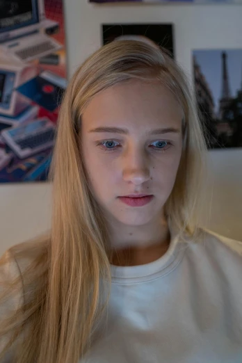a woman sitting in front of a laptop computer, featured on reddit, hyperrealism, blue eyes and blond hair, teenager, close-up portrait film still, in her room
